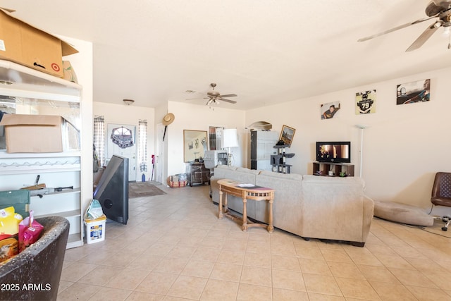 living area featuring light tile patterned floors and a ceiling fan