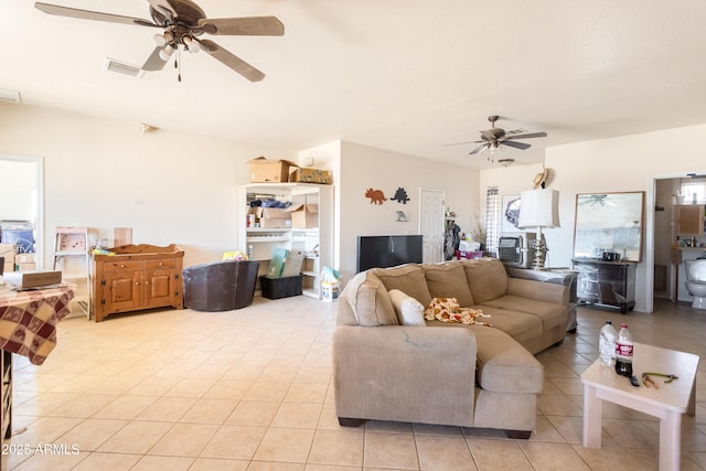 living area featuring ceiling fan, light tile patterned flooring, and visible vents