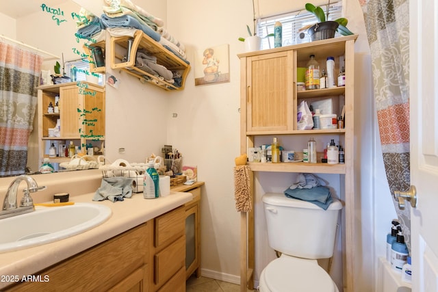 full bath featuring vanity, toilet, and tile patterned floors