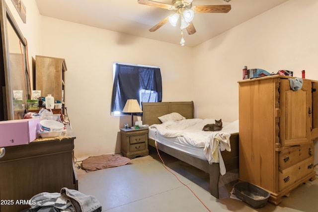 bedroom with ceiling fan and concrete flooring