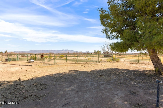 view of yard featuring an exterior structure, an outbuilding, and a rural view