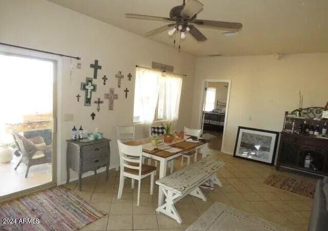 dining room with a ceiling fan and light tile patterned floors