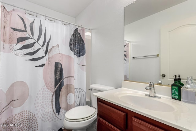 bathroom featuring walk in shower, vanity, and toilet