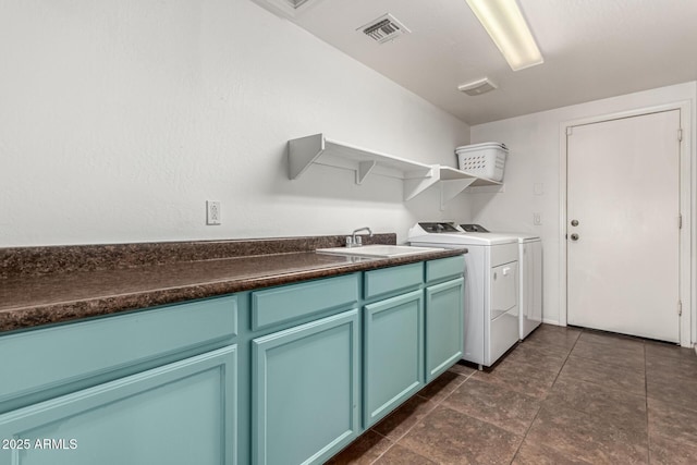 laundry room with washer and dryer, cabinets, and sink