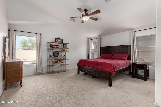 bedroom with ceiling fan, lofted ceiling, and carpet floors