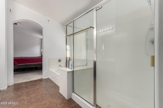 bathroom with independent shower and bath and tile patterned floors