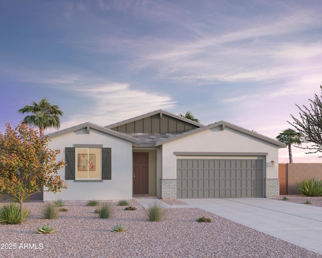 12629 W Luxton Ln, Avondale, AZ 85323 - view of front facade with an attached garage, concrete driveway, brick siding, and stucco siding