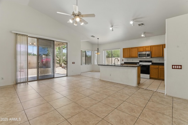 kitchen featuring stainless steel microwave, electric stove, vaulted ceiling, a sink, and dark countertops