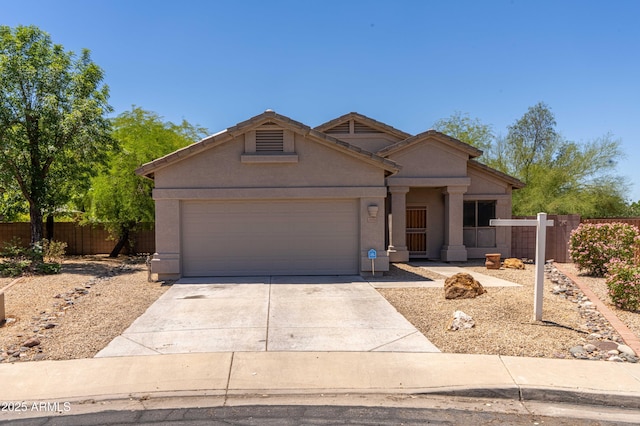 ranch-style home with fence, driveway, a garage, and stucco siding