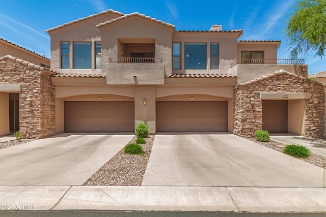 7445 E Eagle Crest Dr Unit 1111, Mesa, AZ 85207 - mediterranean / spanish-style home with a balcony, a tile roof, stucco siding, concrete driveway, and an attached garage