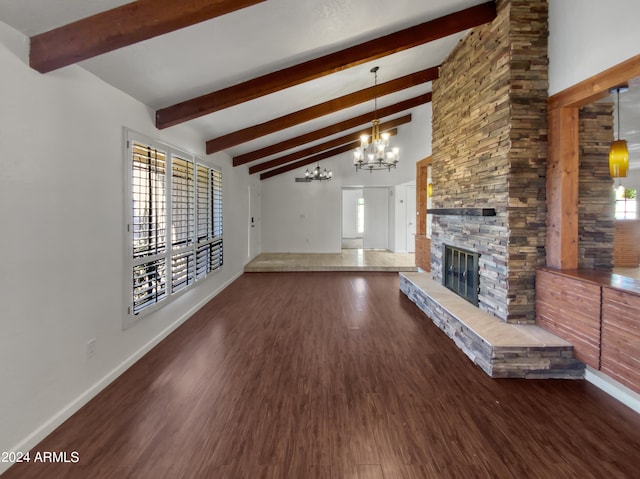 unfurnished living room with a fireplace, lofted ceiling with beams, dark wood-type flooring, and a notable chandelier