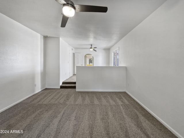 unfurnished living room featuring carpet and ceiling fan