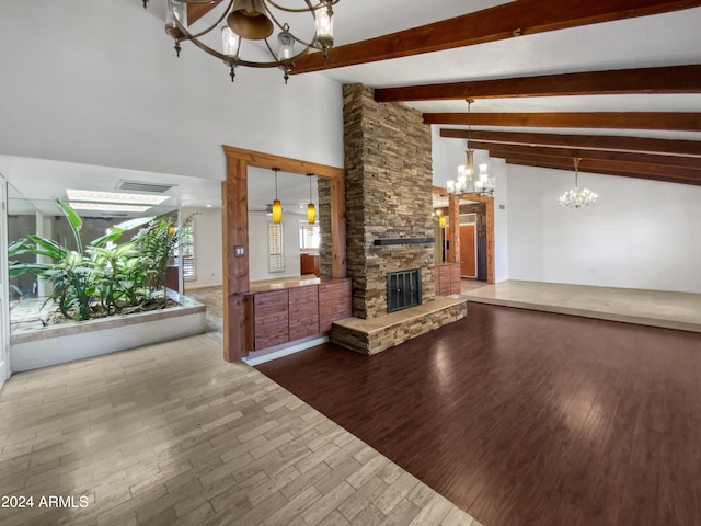 unfurnished living room with an inviting chandelier, beamed ceiling, hardwood / wood-style flooring, and a fireplace