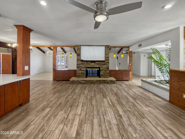 unfurnished living room with ceiling fan, light hardwood / wood-style flooring, a fireplace, and beam ceiling