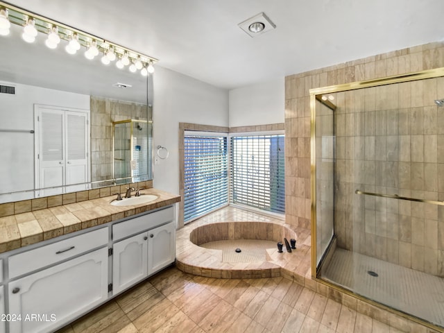 bathroom with plus walk in shower and vanity