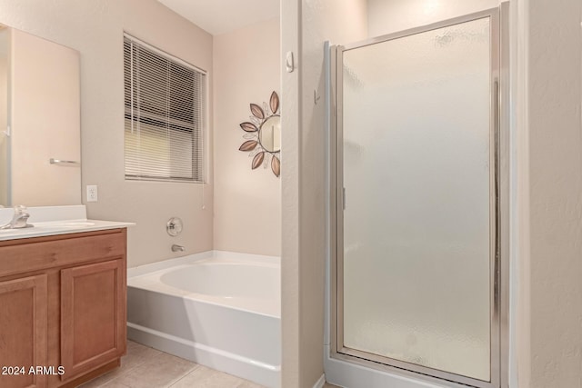 bathroom with tile patterned flooring, shower with separate bathtub, and vanity