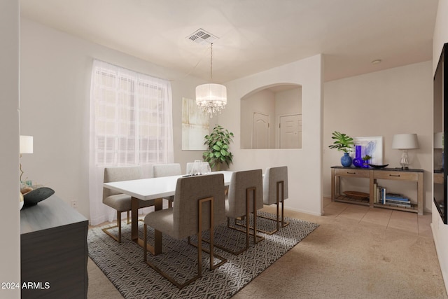 carpeted dining area featuring a chandelier