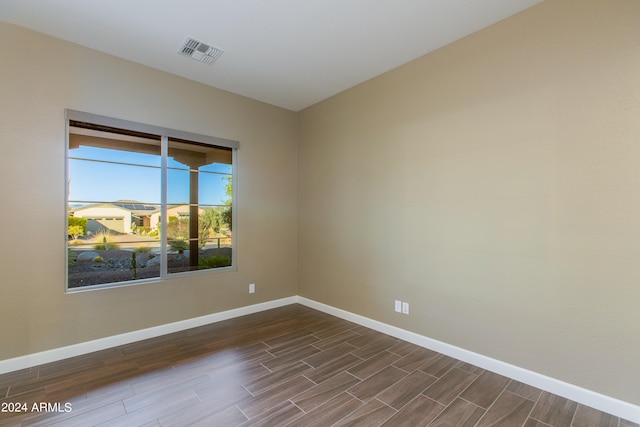 spare room featuring dark wood-type flooring