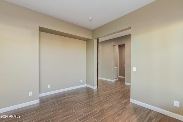 empty room with hardwood / wood-style floors