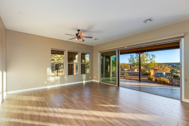 empty room featuring ceiling fan and light wood-type flooring