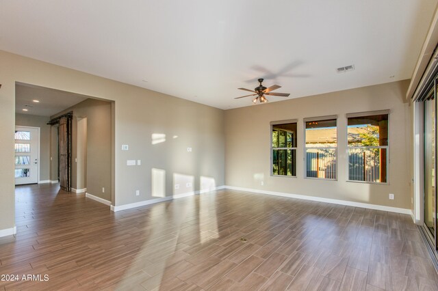 unfurnished room with wood-type flooring and ceiling fan