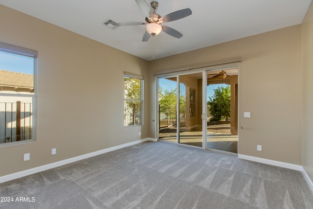 carpeted spare room with ceiling fan