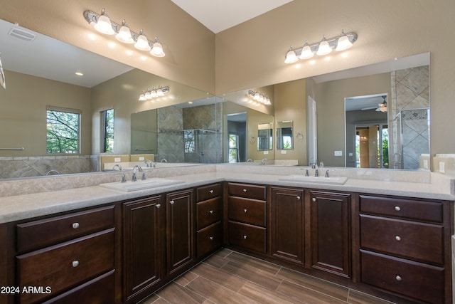 bathroom featuring vanity, a tile shower, and ceiling fan