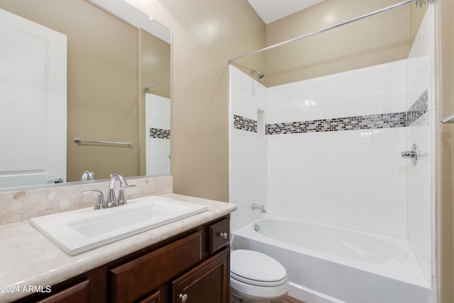 full bathroom featuring vanity, tiled shower / bath combo, and toilet