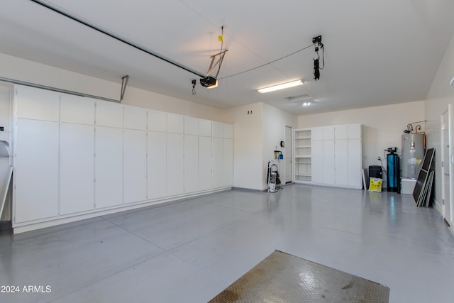 garage with a garage door opener and electric water heater