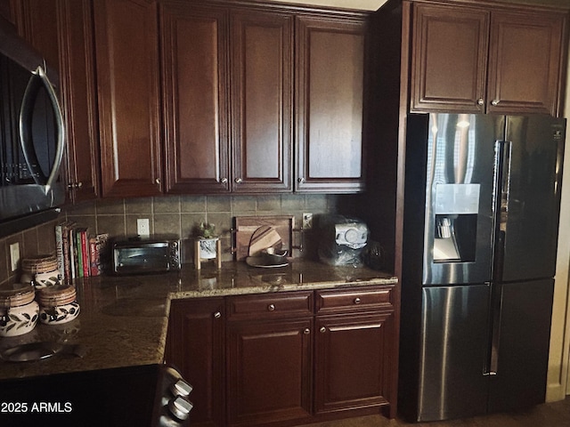 14000 N 94th St Unit 1077, Scottsdale, AZ 85260 - kitchen featuring stainless steel fridge, backsplash, dark stone countertops, and dark brown cabinetry