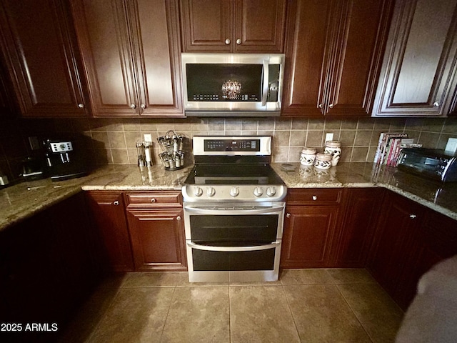 14000 N 94th St Unit 1077, Scottsdale, AZ 85260 - kitchen with appliances with stainless steel finishes, light tile patterned floors, light stone countertops, and tasteful backsplash
