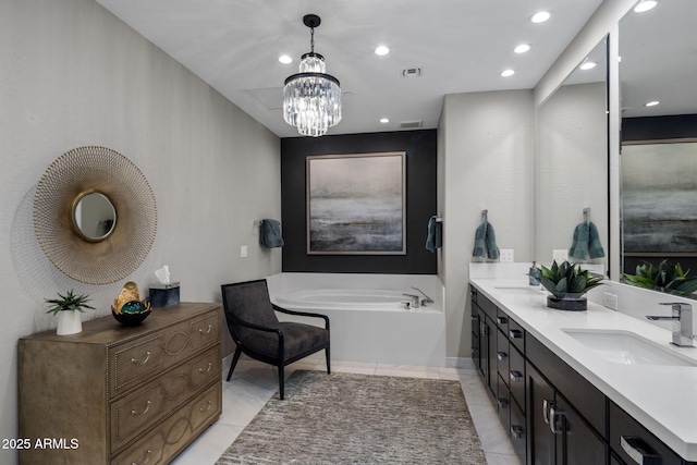 bathroom featuring tile patterned floors, a tub to relax in, a chandelier, and vanity