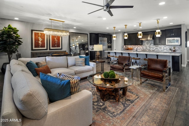 living room with dark wood-type flooring and ceiling fan