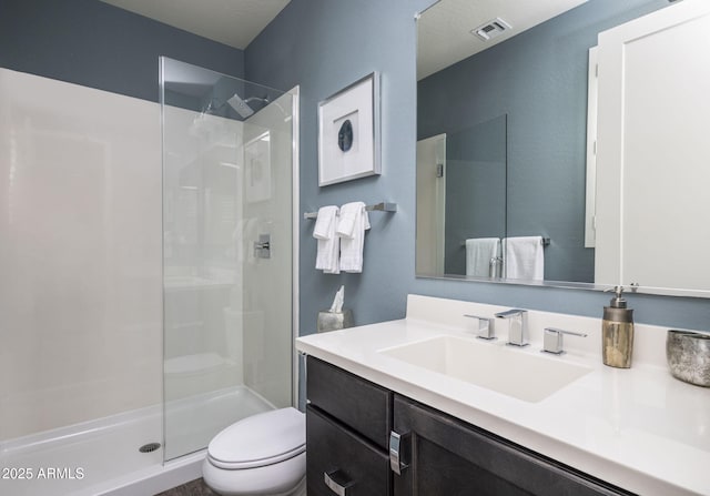 bathroom featuring walk in shower, vanity, and toilet