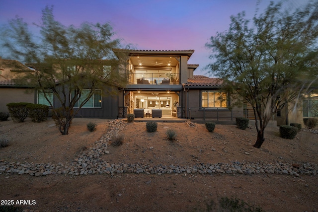 mediterranean / spanish house featuring cooling unit, a patio area, and a balcony