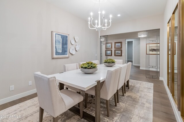 dining room featuring hardwood / wood-style flooring and a chandelier