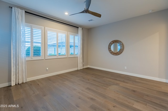 spare room featuring hardwood / wood-style flooring and ceiling fan