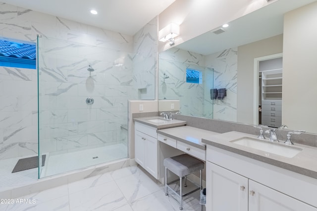 bathroom featuring a tile shower and vanity