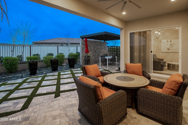 patio terrace at dusk featuring ceiling fan