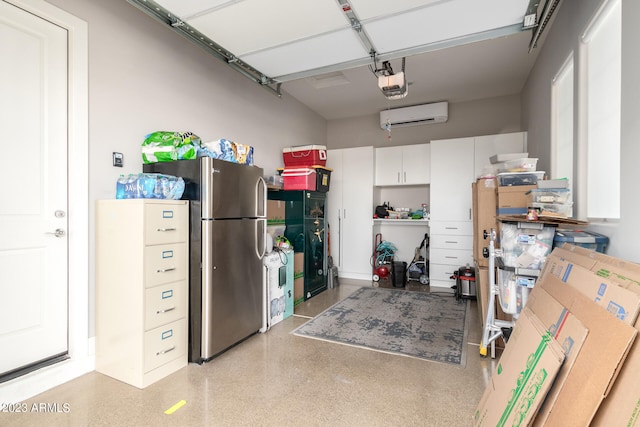 garage featuring a garage door opener, stainless steel refrigerator, and a wall mounted AC