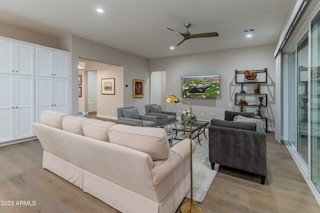 living room with ceiling fan and light wood-type flooring