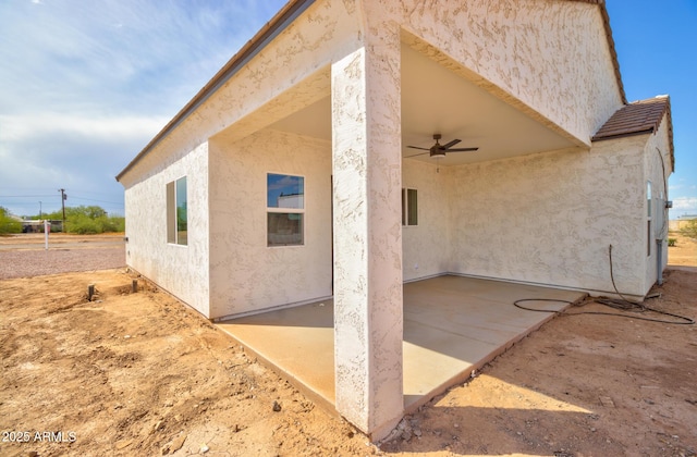 4115 N Monarch Dr, Eloy, AZ 85131 - view of side of property featuring a patio, ceiling fan, and stucco siding