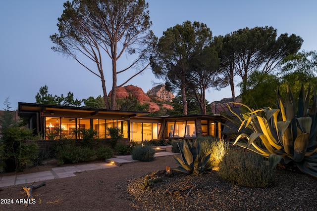 back house at dusk featuring a mountain view