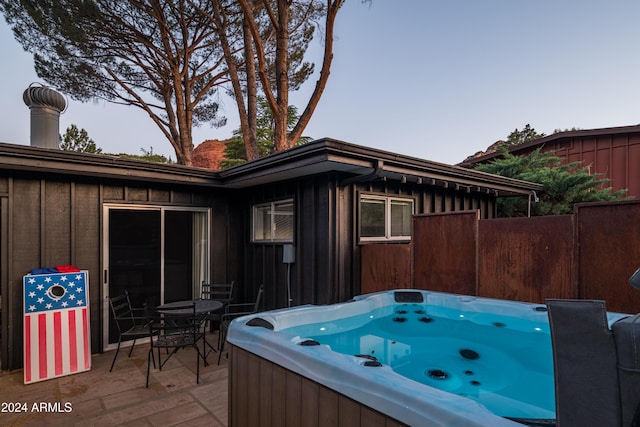 wooden terrace with a patio and a hot tub