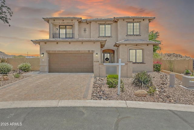 9017 E June Cir, Mesa, AZ 85207 - mediterranean / spanish-style home with stucco siding, an attached garage, decorative driveway, and a tiled roof