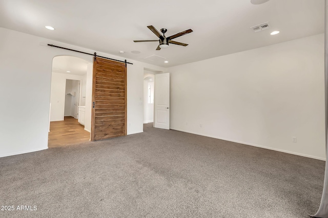 9017 E June Cir, Mesa, AZ 85207 - carpeted empty room with a ceiling fan, recessed lighting, a barn door, arched walkways, and baseboards