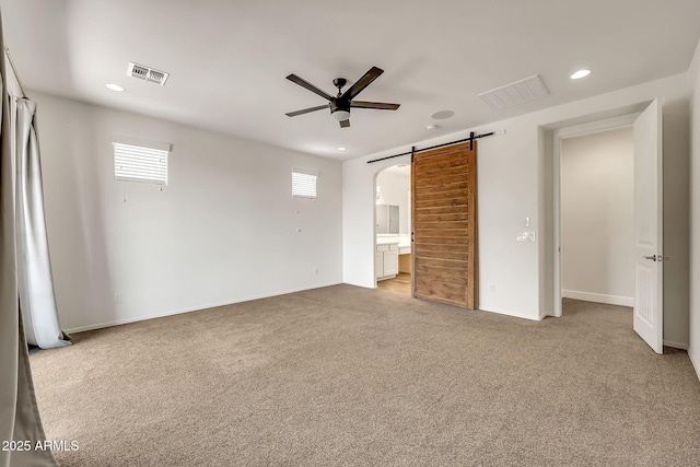 9017 E June Cir, Mesa, AZ 85207 - unfurnished bedroom with a barn door, recessed lighting, light colored carpet, and multiple windows