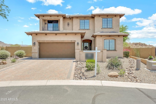 9017 E June Cir, Mesa, AZ 85207 - mediterranean / spanish home featuring stucco siding, a garage, a balcony, decorative driveway, and a tile roof