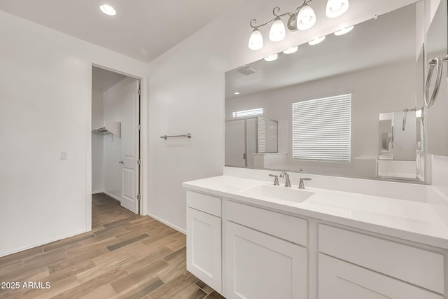 9017 E June Cir, Mesa, AZ 85207 - bathroom featuring wood finished floors, a shower with shower door, vanity, a spacious closet, and recessed lighting