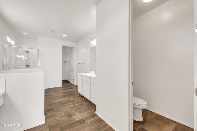 9017 E June Cir, Mesa, AZ 85207 - bathroom with a shower stall, vanity, wood finished floors, toilet, and recessed lighting